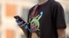 A young man's T-shirt gives him away — he's a Pokemon fan. 
