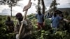 FILE - Health workers carry a coffin containing a victim of the Ebola virus on May 16, 2019 in Butembo. 