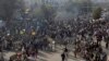 Supporters of religious groups burn tires at a rally to express solidarity with protesters block main highway in capital, Saturday, Nov. 25, 2017 in Peshawar, Pakistan. 