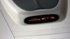 A lighted sign on an airplane instructs passengers to turn off their electronic devices.