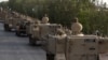 Pakistani army troops ride military vehicles following an operation launched against the Taliban in North Waziristan, in Karachi, Pakistan, Monday, June 16, 2014. Pakistani jets pounded targets in the country's northwest on Monday as the military waged an