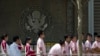 Chinese students wait outside the U.S. Embassy for their visa application interviews in Beijing, China, May 6, 2019.