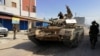 FILE - Troops from eastern Libyan forces are seen in Ain Zara, south of Tripoli, Libya, April 11, 2019. 