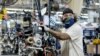 FILE - A person works on a Polaris snowmobile assembly line at their manufacturing and assembly plant in Roseau, Minnesota, June 7, 2021.