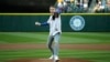 Singer and hip-hop artist Macklemore throws out the first pitch of a baseball game between the Seattle Mariners and the Kansas City Royals, Friday, April 29, 2016, in Seattle.