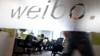 Employees work at their desks at a Sina Weibo office in Beijing's leading microblog site, (File photo).