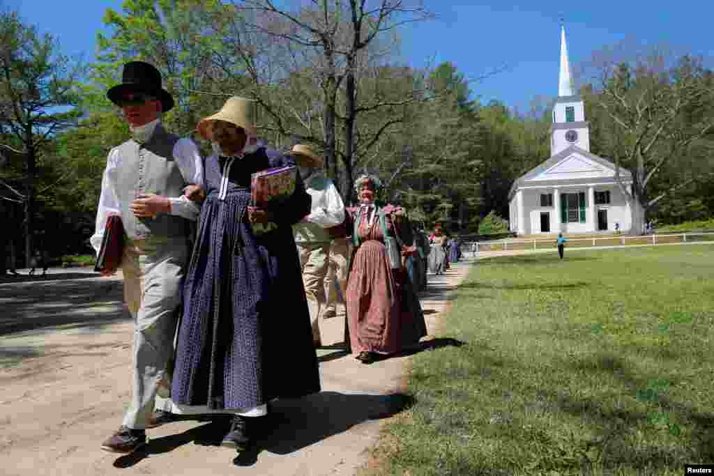 Para anggota paduan suara tiba untuk upacara naturalisasi, di mana 146 imigran diambil sumpahnya menjadi warga negara AS di Sturbridge, negara bagian Massachusetts.