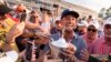 Bryson DeChambeau celebrates with fans and the trophy after winning the U.S. Open golf tournament June 16, 2024, in Pinehurst, N.C.