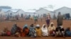 FILE - Congolese families sit at the Kyangwali refugee settlement camp, Uganda, March 19, 2018. 