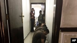 FILE - suspected Islamic State militants wait their turn for sentencing at the counterterrorism court in Baghdad, Iraq, May 23, 2018.