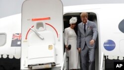 Britain's Prince Harry and Meghan, Duchess of Sussex disembark from their plane on their arrival in Suva, Fiji, Oct. 23, 2018.