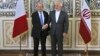 Iranian Foreign Minister Mohammad Javad Zarif, right, and his French counterpart Jean-Yves Le Drian, shake hands for journalists at the start of their meeting in Tehran, March 5, 2018. 