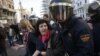 Protesters are pushed away by Spanish police officers during a 24-hour nationwide general strike in central Madrid November 14, 2012.
