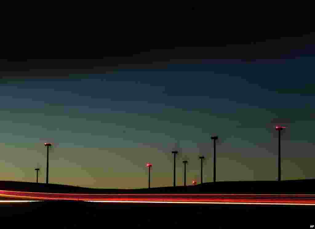 Blades on wind turbines spin to produce electricity at a wind farm near Ellsworth, Kansas, USA, Dec. 8, 2015.