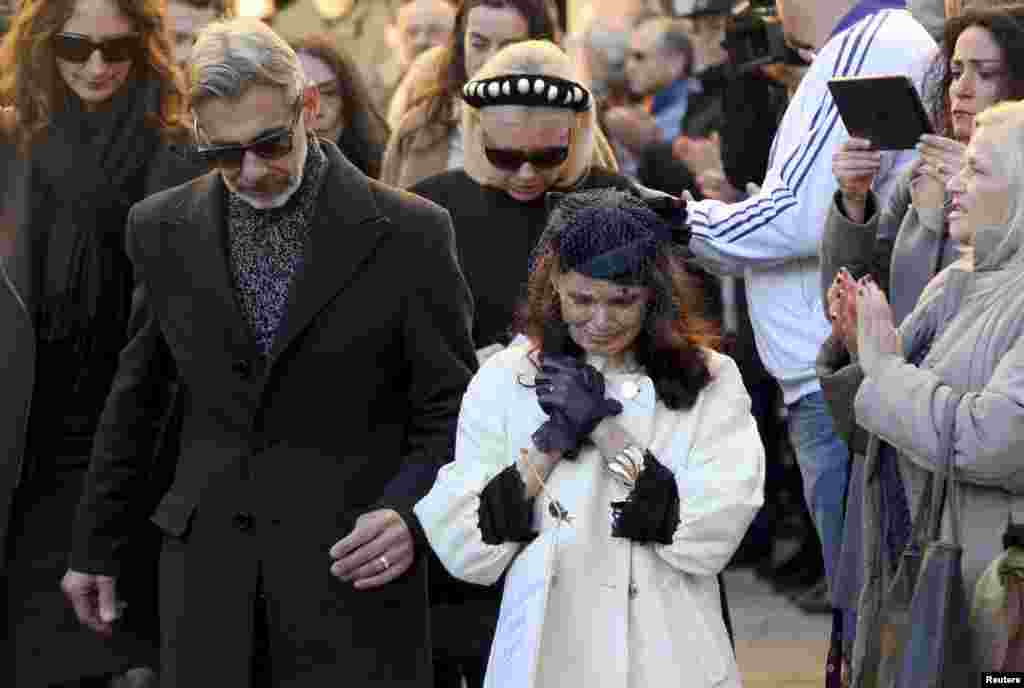 The father and mother of Ashley Olsen leave a church after their daughter&#39;s funeral in Florence.&nbsp; Police arrested a Senegalese illegal immigrant who prosecutors believe killed the U.S. woman, who was found dead in her apartment in the Italian city last weekend.