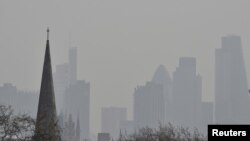 FILE PHOTO: City of London financial district is seen from Primrose Hill as high air pollution obscures the skyline over London