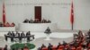 Ismet Yilmaz, head of the parliament's national defense committee from the ruling AK Party, addresses lawmakers at the Turkish Parliament in Ankara, Turkey, Jan. 2, 2020. 