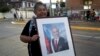 A supporter of the late Chilean President Sebastian Pinera holds a framed photo of him, in Santiago, Chile, Feb. 6, 2024. The two-time former president died Tuesday in a helicopter crash. He was 74.