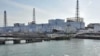 A US military barge carrying pure water (bottom) leaves the quay near Tokyo Electric Power Co.'s Fukushima Daiichi Nuclear Power Plant on April 4, 2011.