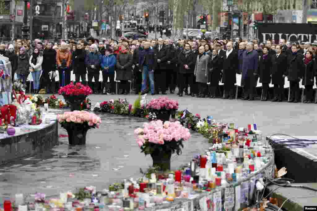 People attend a ceremony at Place de la Republique square in Paris, to pay tribute to the victims of last year&#39;s shooting at the French satirical newspaper Charlie Hebdo.