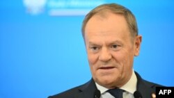 Poland's Prime Minister Donald Tusk addresses a press conference with his British counterpart after talks at the Prime Minister's Office building in Warsaw, Poland, on January 17, 2025. (Photo by Sergei GAPON / AFP)