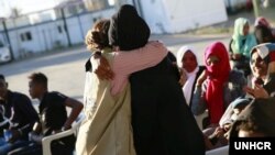 Relieved and happy to be released from detention, a refugee hugs UNHCR staff as they meet at the Gathering and Departure Facility in Tripoli, Libya. (UNHCR/Mohamed Alalem)