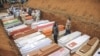 Civilians and Red Cross volunteers are seen at the Feb. 4, 2022, burial of 62 displaced people who were massacred on the night of Feb. 1, 2022, at the Plaine Savo IDP camp near Bule, Ituri province, northeastern Democratic Republic of Congo. 