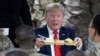 President Donald Trump holds up a tray of Thanksgiving dinner during a surprise Thanksgiving Day visit to the troops,Nov. 28, 2019, at Bagram Air Field, Afghanistan.