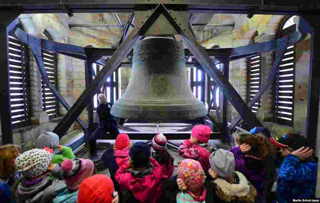 Pre-school children look at the Gloriosa, the trinity bell from 1721 and the world's largest free-swinging medieval bell, in the Erfurt Cathedral, in Erfurt, Germany.