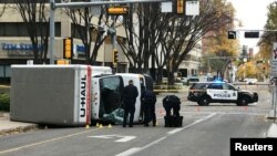Police investigate at the scene where a man hit pedestrians, then flipping the U-Haul truck he was driving, in Edmonton, Alberta, Canada, Oct. 1, 2017.