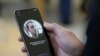 FILE - An Apple employee demonstrates the facial recognition feature of an iPhone in San Francisco. A new Apple tool called "neuralMatch" will detect known images of child sexual abuse on phones without decrypting people's messages.