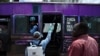 A government health official sprays a chlorine solution on a public transport vehicle as a preventive measure against the COVID-19 coronavirus in Nairobi, March 19, 2020.
