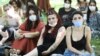 Women wearing protective masks look on during a protest organised by Ankara Women's Platform in Ankara, on July 26, 2020, in support of a landmark treaty on combating violence against women.