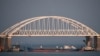 FILE - A Russian tanker under the Kerch bridge blocks the passage to the Kerch Strait near Kerch, Russia-annexed Crimea, Nov. 25, 2018.