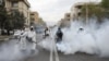FILE - Firefighters wear protective face masks, amid fear of the coronavirus disease, as they disinfect the streets in Tehran, Iran, March 18, 2020. 