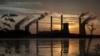 FILE - The coal-fired Plant Scherer, one of the nation's top carbon dioxide emitters, stands in the distance in Juliette, Georgia, June, 3, 2017.