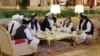 FILE - Members of the Taliban delegation are seen at the Sheraton Doha, before the start of the intra-Afghan dialogue, in Doha, Qatar, July 7, 2019.