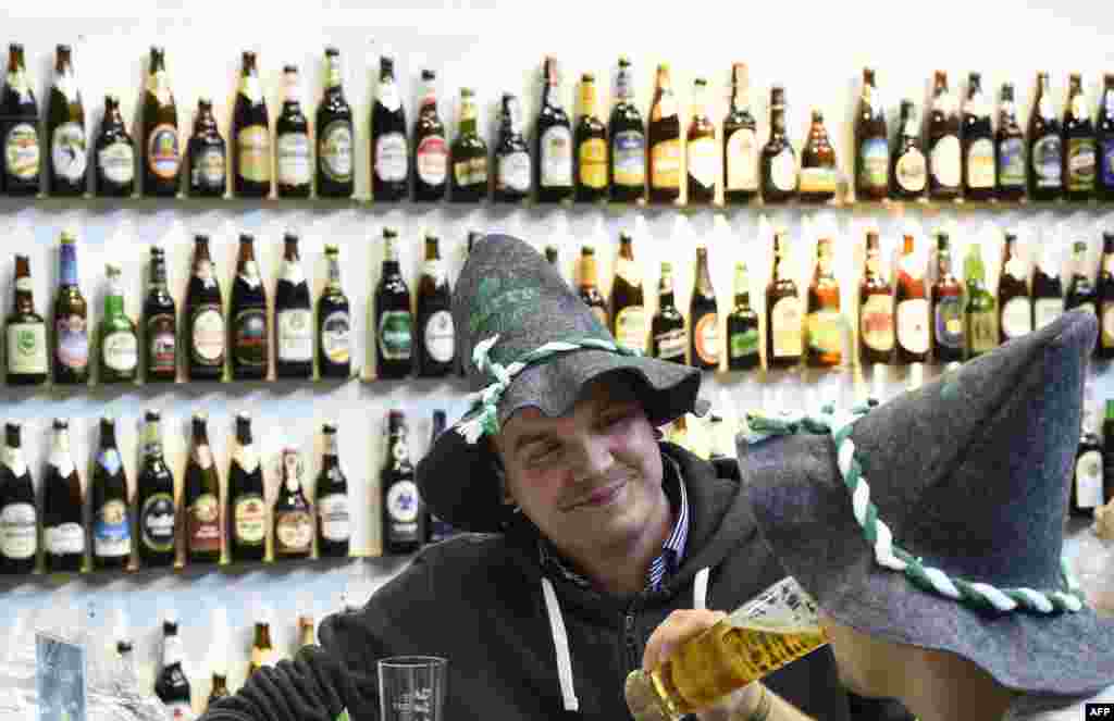 Visitors drink beer at the opening day of the "Gruene Woche" (Green Week) agricultural fair in Berlin. Since April 23, 1516 a "purity decree" rules the composition of German beers.