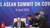 Vietnamese Prime Minister Nguyen Xuan Phuc, left, and his staff prepare documents ahead of the Special ASEAN summit on COVID-19 in Hanoi, Vietnam Tuesday, April 14, 2020. 