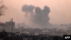 A picture taken from Sderot shows plumes of smoke rising above the Gaza Strip during Israel strikes on November 3, 2023, amid the ongoing battles between Israel and the Palestinian group Hamas. (Photo by JACK GUEZ / AFP)