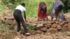 Beneficiaries of WFP's Resilent Program in Zomba, Malawi, construct blockades across rivers to help trap water runoffs during flooding.