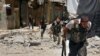 This Tuesday, July 9, 2013 citizen journalism image provided by Aleppo Media Center AMC, which has been authenticated based on its contents and other AP reporting, shows Syrian rebels running during heavy clashes with Syrian troops.