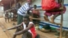 Victims of mutilations perpetrated by rebels of the Revolutionary United Front (RUF) gather at the Handicap International camp in Freetown, May 18, 2000. (AFP) 