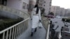 A women is seen walking toward her apartment building in Beijing, Feb. 10, 2015. An emotional video ad about “leftover women” in China has gone viral, uncovering the society’s deep-rooted discrimination against single women.
