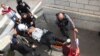 Israeli medics carry a wounded Israeli following a stabbing attack in a light rail train in Jerusalem, Nov. 10, 2015. 