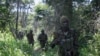 FILE - Soldiers of the Uganda People's Defence Force (UPDF) patrol in the jungle in the Central African Republic as they look for Lord's Resistance Army (LRA) fighters.