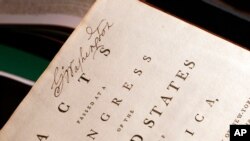 FILE- George Washington's signature is seen on his personal copy of the Acts of the first Congress (1789), containing the U.S. Constitution and the proposed Bill of Rights.