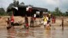 People wash and bathe in a village on the banks of the river Nun in Nigeria's oil state of Bayelsa, Nov. 27, 2012. 