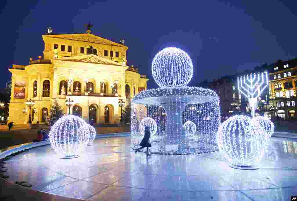 Strings of lights are fixed on the fountain in front of the Old Opera as Christmas decorations in Frankfurt, Germany.