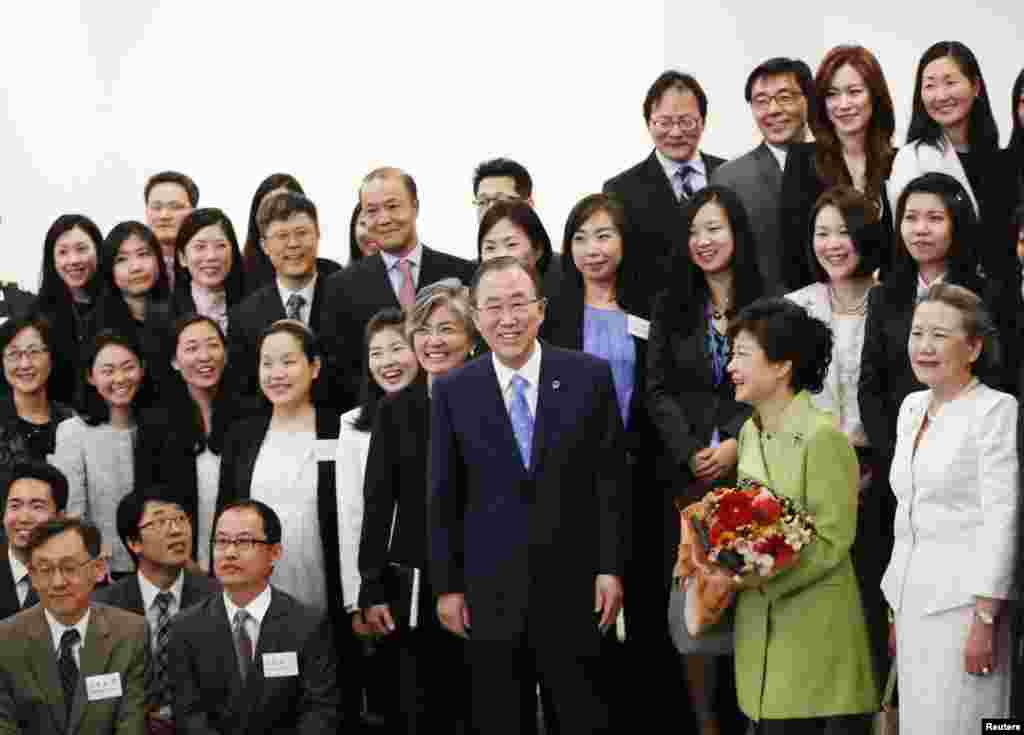 U.N. Secretary-General Ban Ki-moon and South Korean President Park Geun-hye pose for a photo with staff members at U.N. headquarters in New York, May 6, 2013. 
